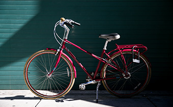 red kimpton bike against blue wall